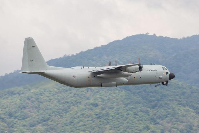 Chaing Mai Thailand 25 Aug 2016 : Royal Thai air force C-130 Was taking off from Chaing mai airport and gear up pass mountain.