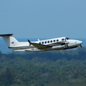 Phuket, Thailand. December 25, 2016. Siam Land Flying CO., Ltd Beechcraft King Air 350iER Reg. HS-CPA Taking Off from Phuket International Airport with Landscape and Seascape Background.