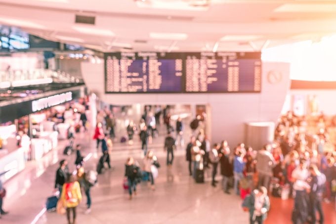 Blur background of people waiting indoor airport gates - Travel with flights concept - Defocused image - Soft rose quartz filtered look with artificial sunlight