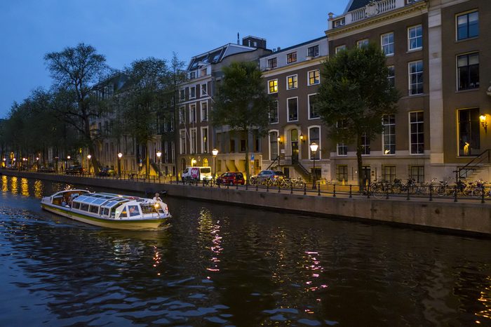 Canal cruise in the city of Amsterdam by night - AMSTERDAM / THE NETHERLANDS - JULY 19, 2017
