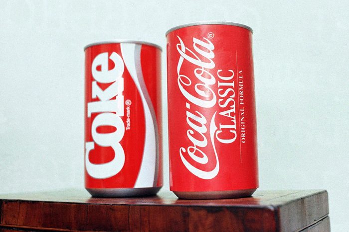 Cans of New Coke and Coca-Cola Classic are on display during a news conference in Atlanta. New Coke's sweeter formula was a marketed as an improved replacement for the flagship soda, but the outcry was immediate and sustained. Coke tried to sell both versions for awhile, but eventually reverted to "Coca-Cola Classic