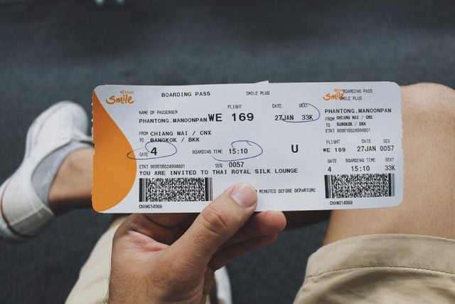 Chiangmai, Thailand - January 17, 2018 : close-up hands hold boarding pass from Chiangmai airport to Bangkok Thailand of Thai Smile airlines .