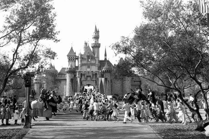 Children sprint across a drawbridge and into a castle that marks the entrance to Fantasyland at the opening of Walt Disney's Disneyland in Anaheim, Calif. Fantasyland had been closed until late in the day