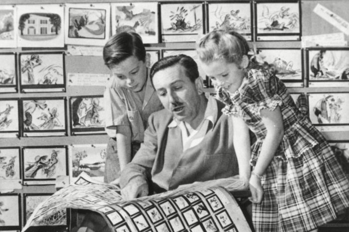 December 27, 1946 - Walt Disney shows 2 young actors, Bobby Driscoll (left), and Luana Patten (right) the storyboards for his new production, "Song of the South."