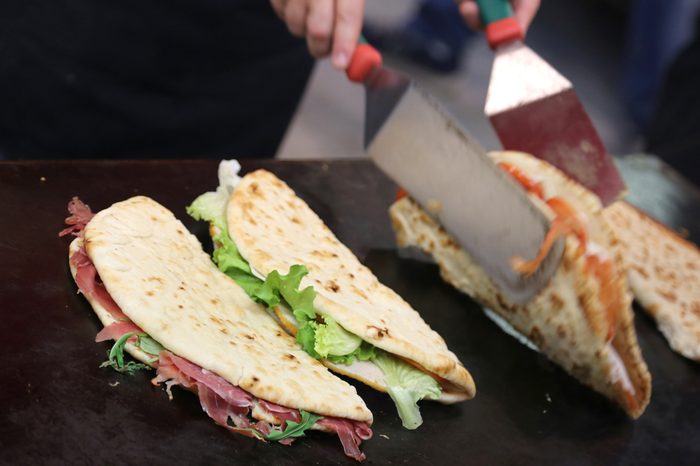 piadina in the roaring grill of the outdoor restaurant during the village festival