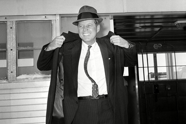 KENNEDY Sen. John F. Kennedy, D-Mass., is seen wearing a hat as he puts on his coat at Mitchell Airport before flying to Omaha from Milwaukee, Wis., . Kennedy formally announced today his intention to enter the April 5 Wisconsin presidential preference primary
