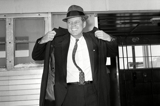 KENNEDY Sen. John F. Kennedy, D-Mass., is seen wearing a hat as he puts on his coat at Mitchell Airport before flying to Omaha from Milwaukee, Wis., . Kennedy formally announced today his intention to enter the April 5 Wisconsin presidential preference primary