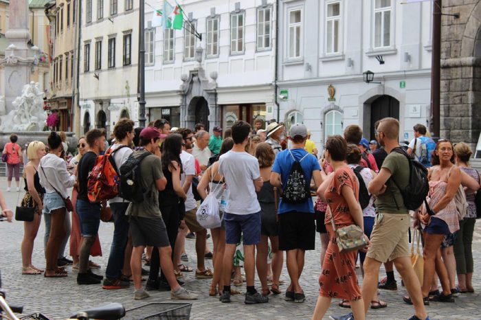 Ljubljana / Slovenia - 2017 : A crowd of tourists, standing and listening their guide during walking tour