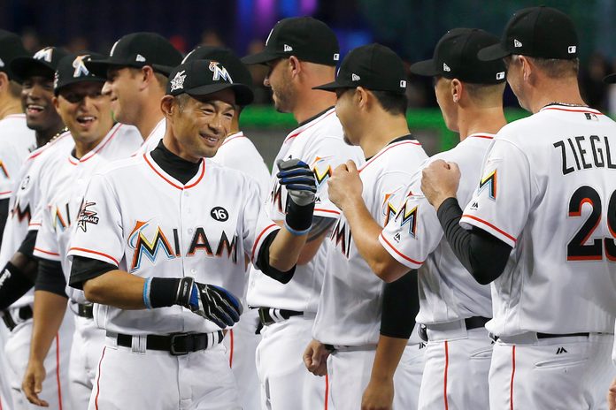 Miami Marlins' Ichiro Suzuki, of Japan, greets teammates during team player introductions before the start of a baseball game against the Atlanta Braves, in Miami
