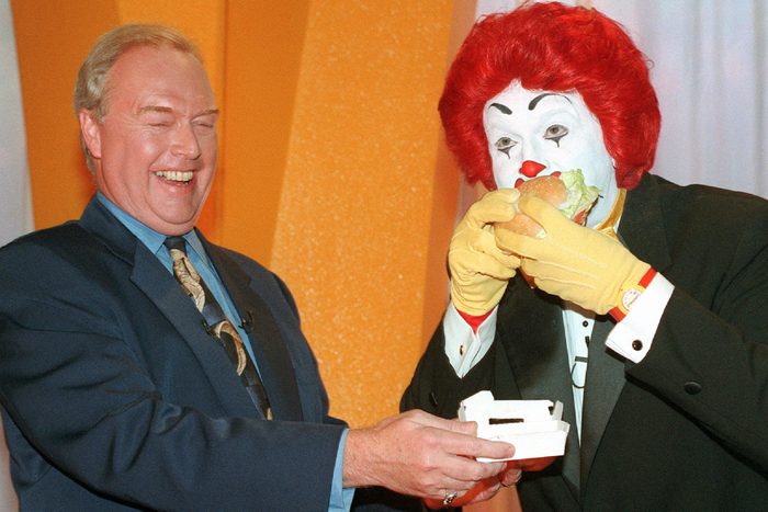 QUINLAN Michael R. Quinlan, chairman and chief executive officer of McDonald's Corporation, left, laughs as Ronald McDonald eats the new Arch Deluxe hamburger unveiled during a news conference at New York's Radio City Music Hall . The event, the largest new product launch in the company's history, is aimed at drawing more adults into the fast-food chain