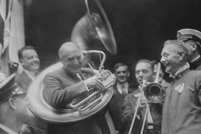 Republican Presidential nominee Warren Harding encircled by a sousaphone. August 1920. This created an amusing image for his 'front porch' campaign in 1920.
