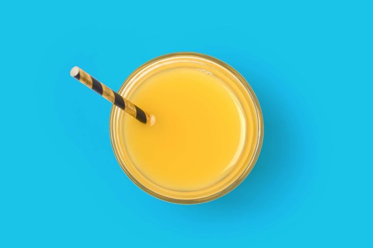 Orange juice glass with straw