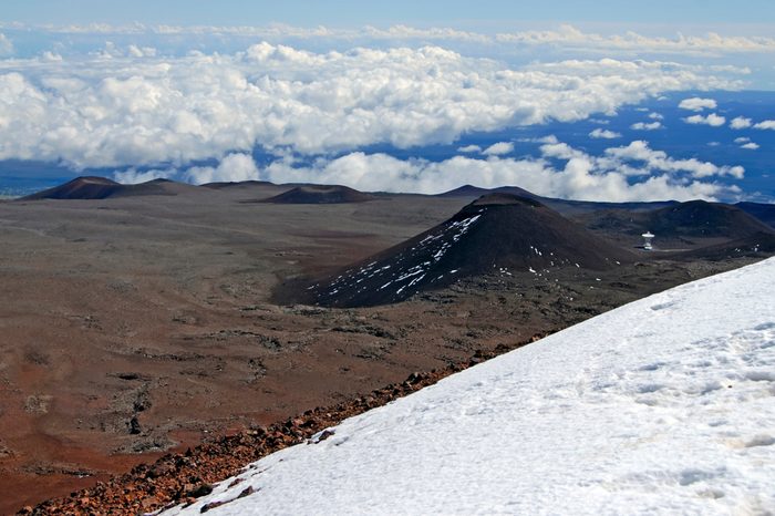 Red sands of Mauna Kea volcano, a popular mountain to hike and climb on the Big Island of Hawaii, USA located on The Ring of Fire 