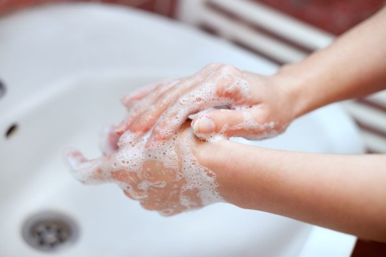 Washing of hands with soap in bathroom. Hand cleaning.