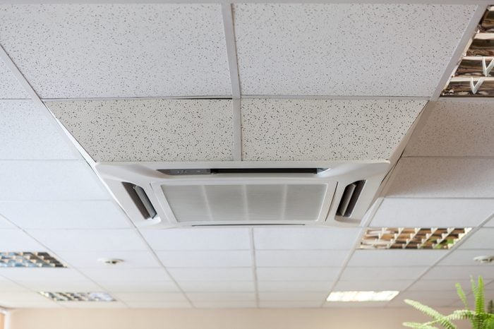 Suspended tile ceiling with high-capacity air conditioner unit, office room