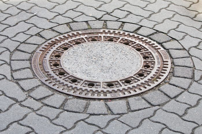 Cast iron manhole cover or gully cover on a street