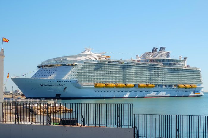 Malaga, Spain - March 27, 2018. Luxury cruise ship Symphony of the seas anchored in the harbor of Malaga