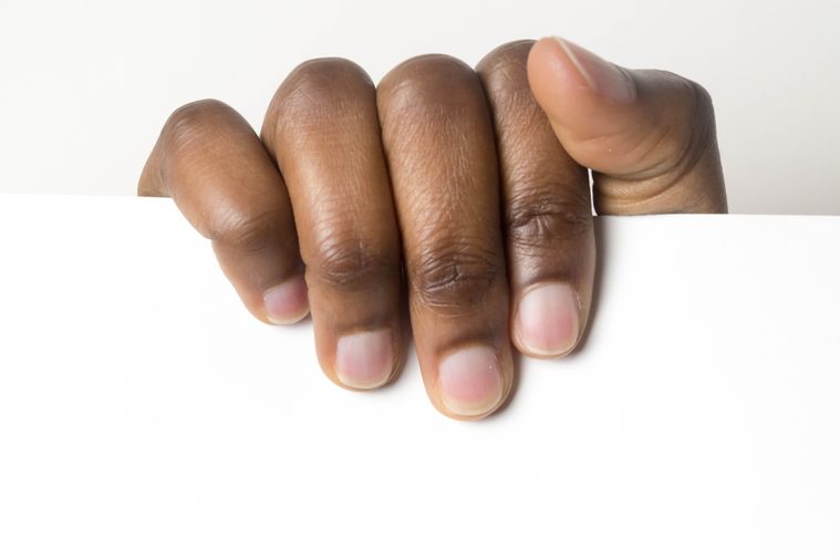 Close up of African American man dark brown skin woman hand and holding blank white advertising card