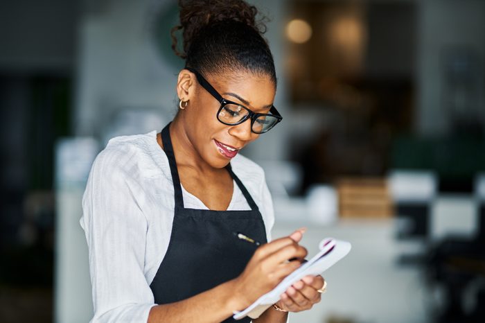 african american waitress taking order on notepad