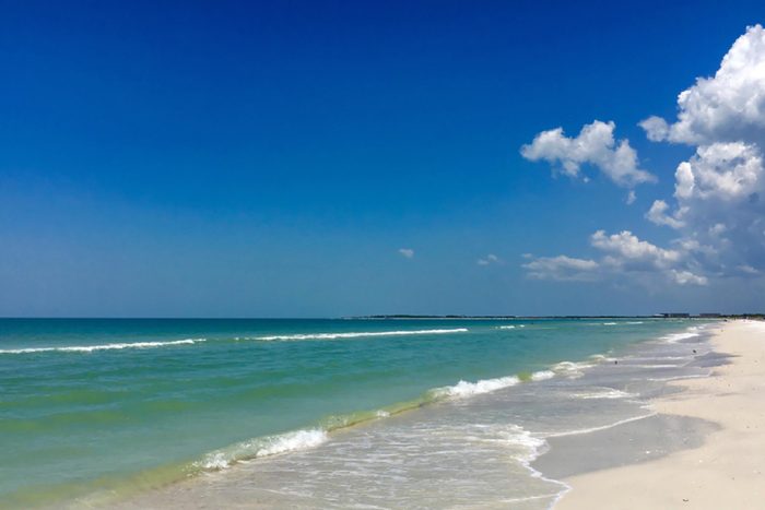 White sand beach with blue green waves at a Beach at Caladesi Island State Park, Florida