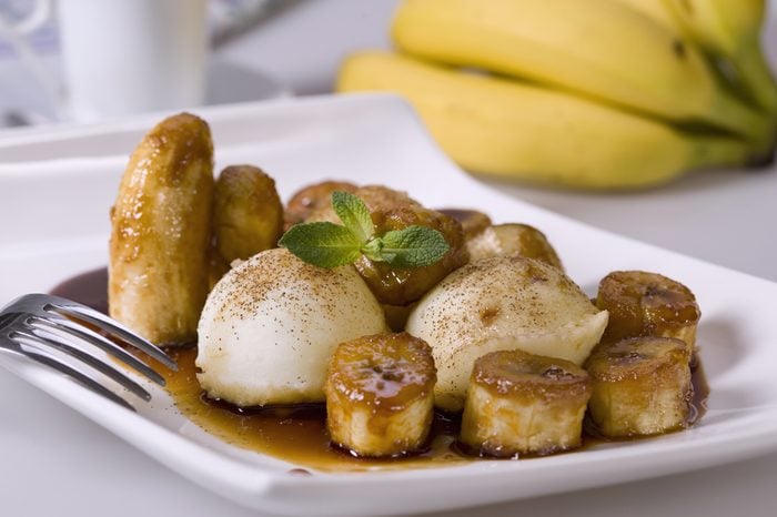 Bananas Foster-style dish on white. Typical American food.
