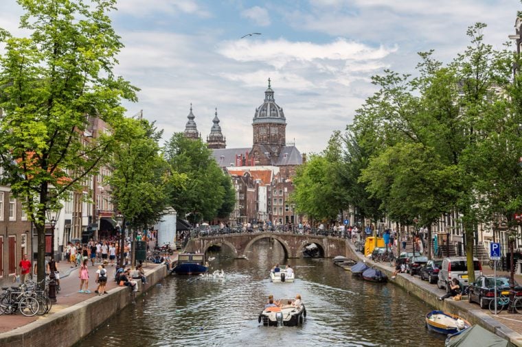 Canal and St. Nicolas Church in Amsterdam, Netherlands in a summer day