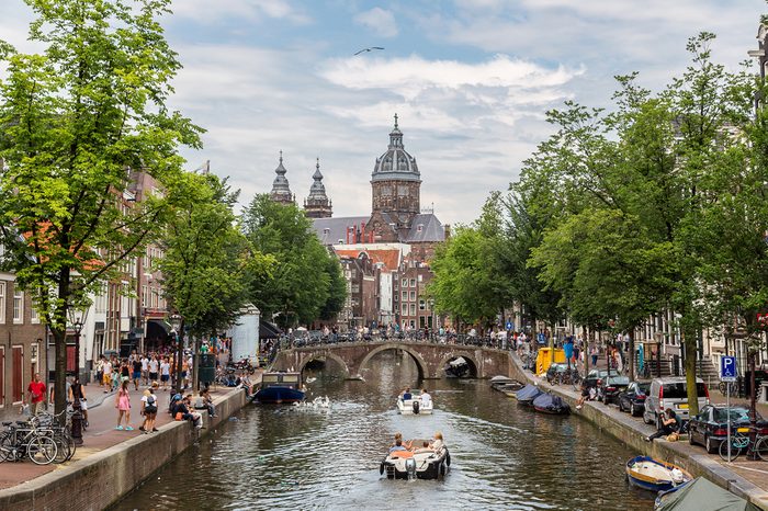 Canal and St. Nicolas Church in Amsterdam, Netherlands in a summer day