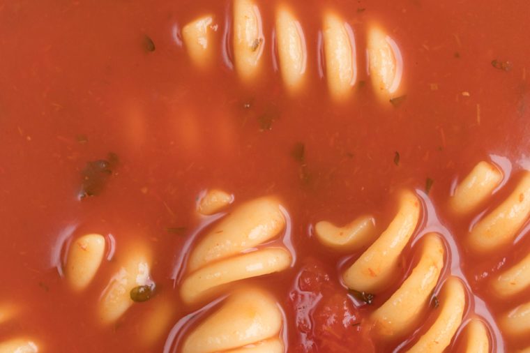 Very close view of rotini tomato soup.