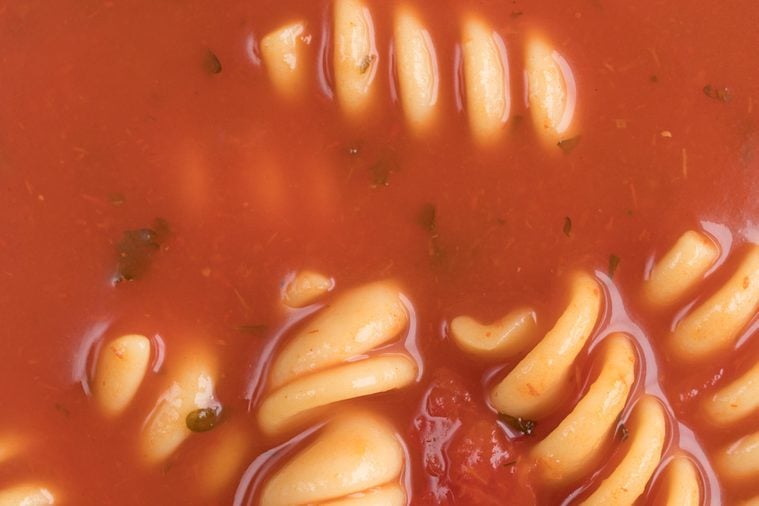 Very close view of rotini tomato soup.