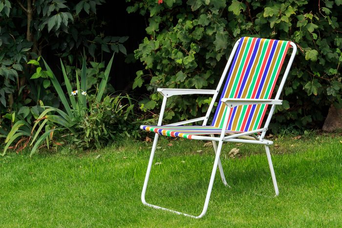  Rainbow colour striped Deck Chair on lawn 
