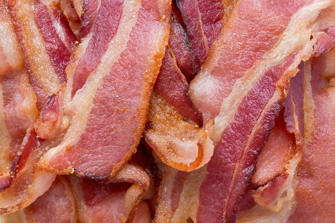 Background texture of fried bacon strips.