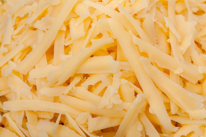 Grated cheese background. Close up, top view.
