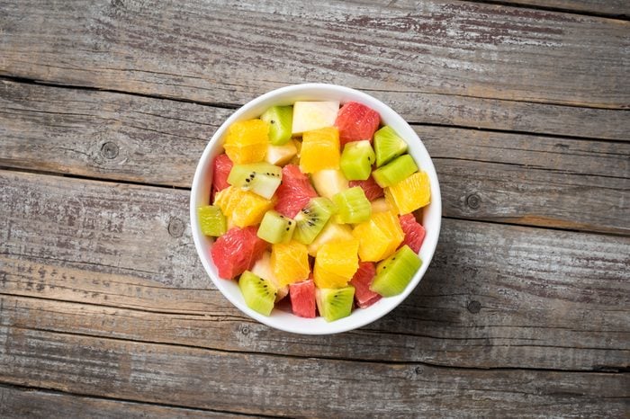 Fresh fruit salad on an old wooden background