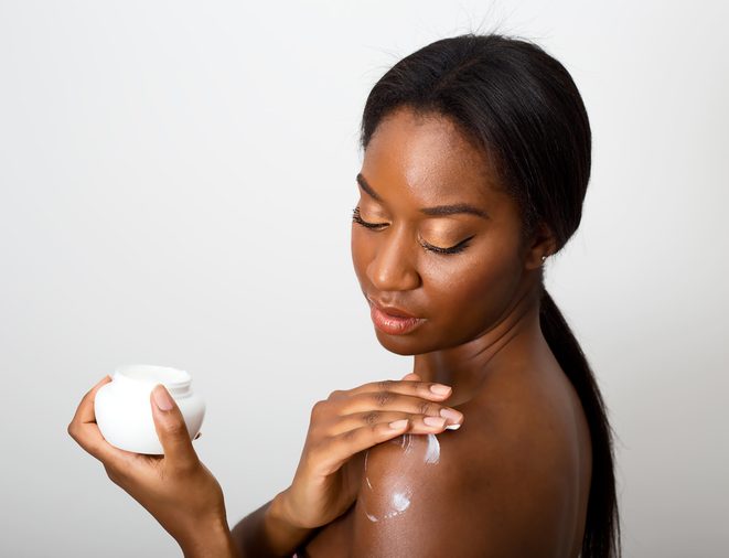african american beauty applying skin cream