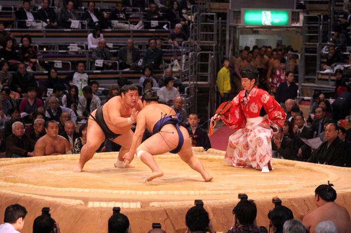 FUKUOKA, JAPAN - NOVEMBER 19: Unidentified Sumo wrestlers ready to engage in the arena of the Fukuoka Tournament on November 19, 2010 in Fukuoka, Japan.