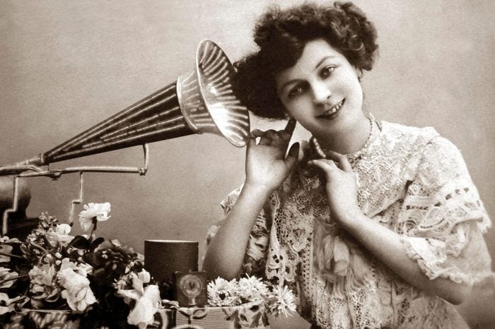 Woman listening to music with gramophone