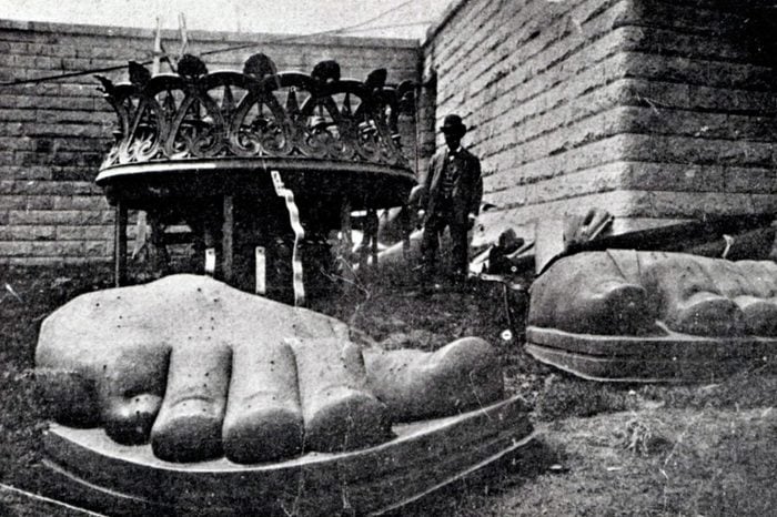 The feet of the Statue of Liberty arrive on Liberty Island 1885. The statue was a gift from the people of France to the United States, It represents Libertas, the Roman goddess of freedom.