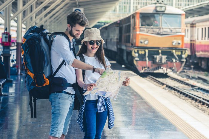 Multiethnic Travelers are looking at the map at the train station, Travel and transportation concept