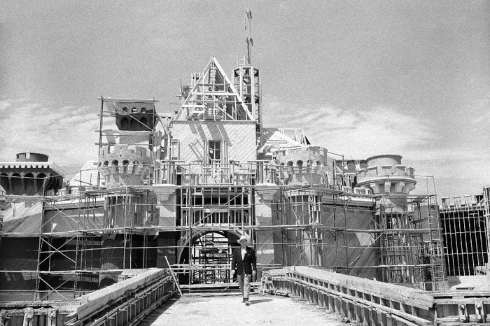 Walt Disney crosses the drawbridge that serves as the entrance to the castle in what will be the heart of Disneyland, in California on April 16, 1955. It's located at the end of Main Street and will house part of Fantasyland. This is the castle where you can see the dining hall awaiting the returning King Arthur's Knights, Sleeping Beauty slumbering, Peter Pan ride, Alice in Wonderland's story and many others. (AP Photo/David F. Smith)