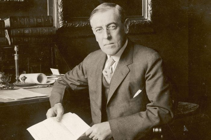 Woodrow Wilson 28th President of of U S Seated at His Desk and Holding A Document 1856 - 1924