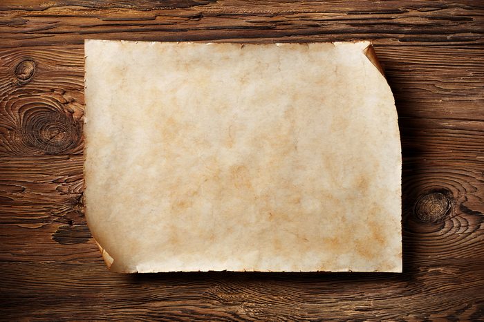 old blank parchment on aged wood background,horizontal