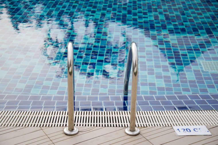 Stainless ladder on the edge of swimming pool