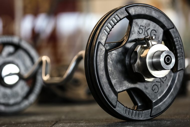 Close up view of barbell on floor in gym