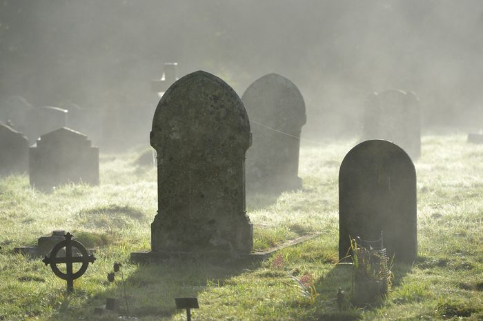 Misty graveyard,crosses and graves backlit