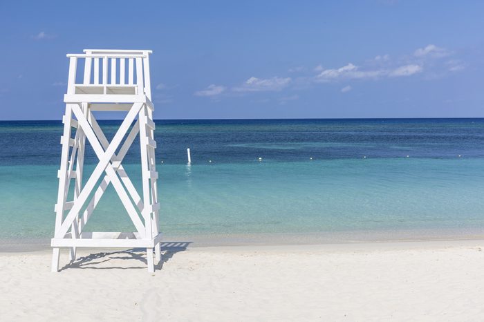 A white lifeguard tower near the tranquil waters off West Bay Beach in West Bay, Roatan, Hoduras