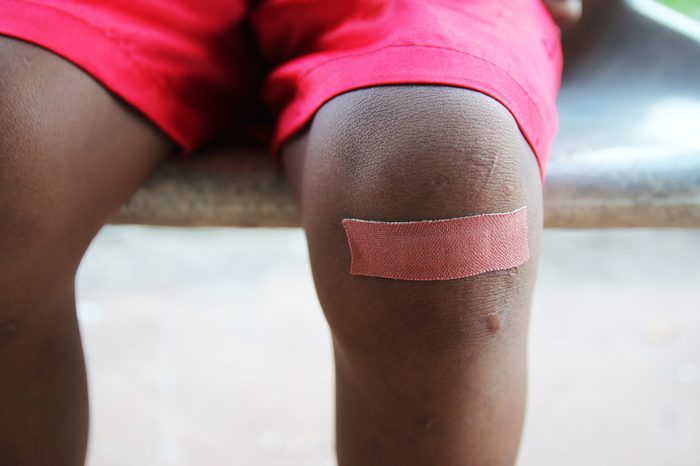 Child knee with an adhesive bandage