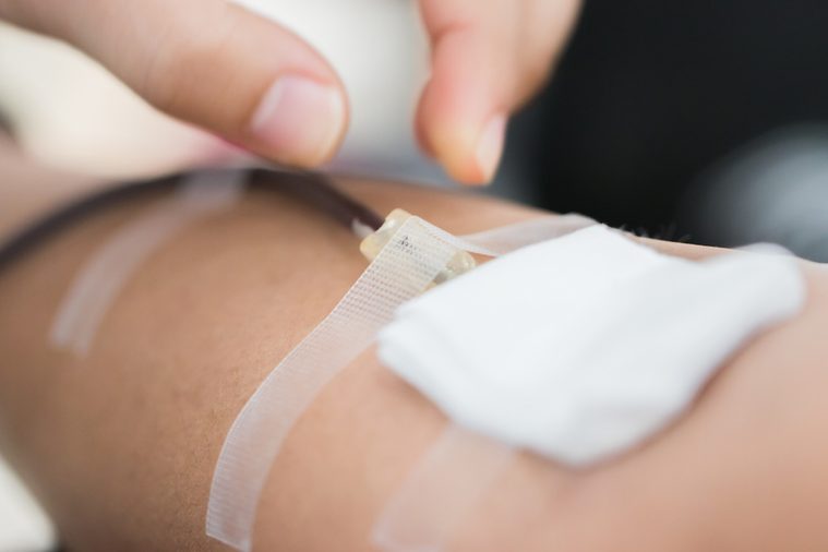 Health and Medical : Nurses use fingers press needles pierce vein in arm for blood donation. Blood donation occurs when voluntarily has blood drawn used for transfusions. World blood donor day June 14