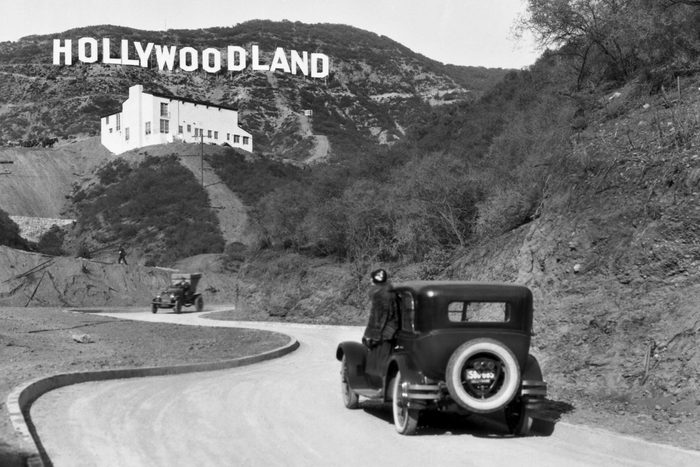 Mandatory Credit: Photo by Underwood Archives/UIG/Shutterstock (3838241a) Hollywood, Los Angeles:  c. 1924 A sign advertises the opening of the Hollywoodland housing development in the hills on Mulholland Drive overlooking Los Angeles. The white building below the sign is the Kanst Art Gallery, which opened on April 1, 1924 VARIOUS