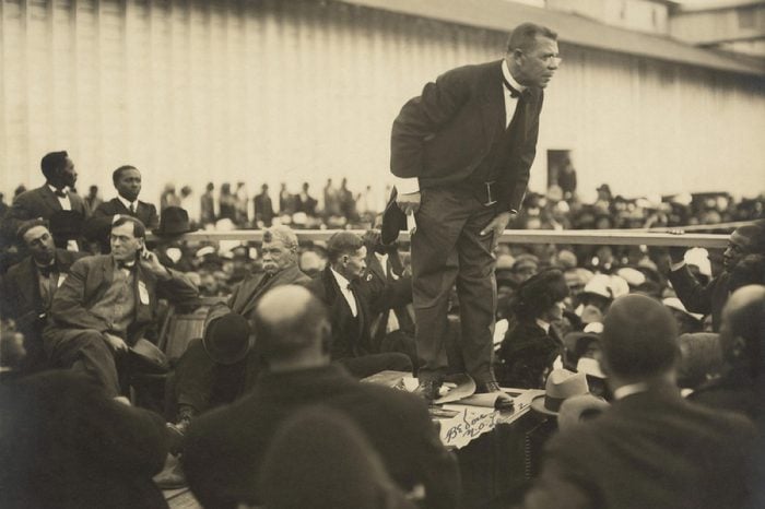 Booker T. Washington (1856-1915), speaking on a raised platform in Mound Bayou, Mississippi. 1912 photo by Arthur P. Bedou.