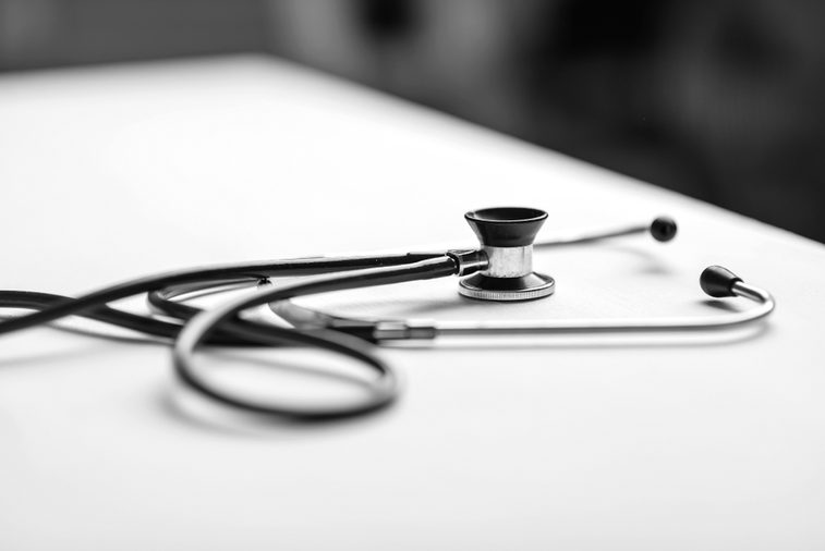 Stethoscope on a table in a doctor's office black and white poster